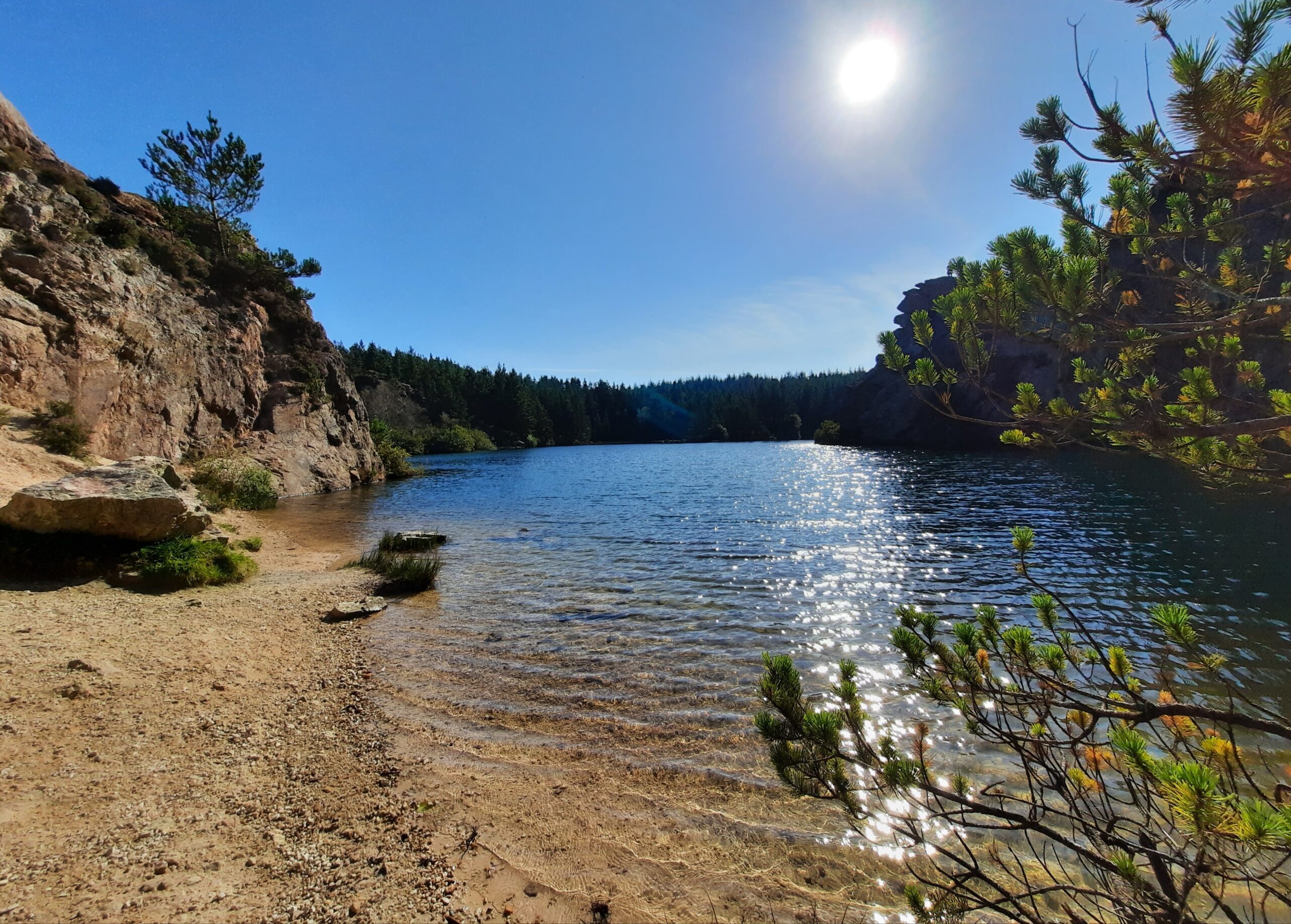 Carrickfoyle Quarry lakeside with tall trees around the perimeter