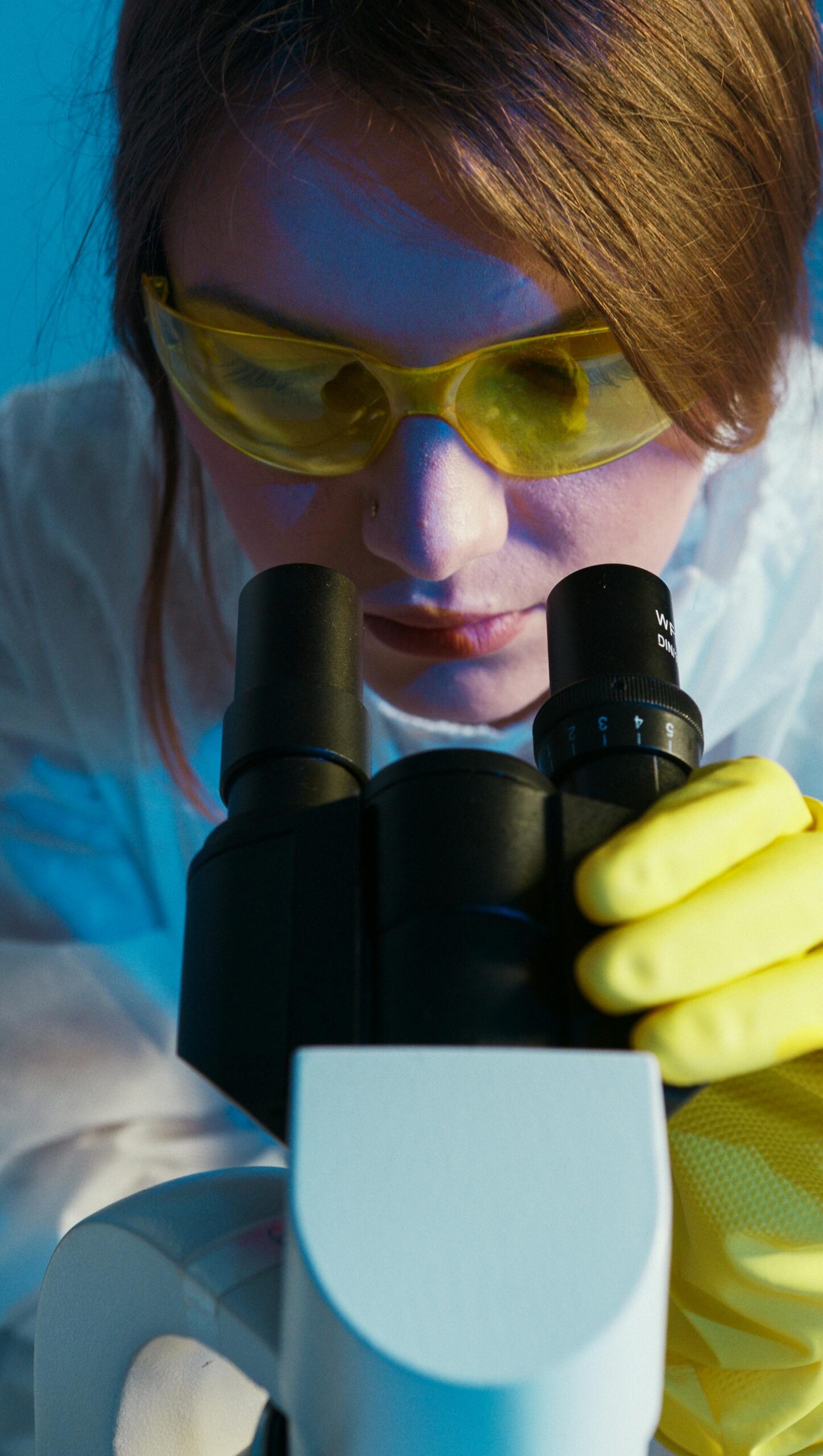 Scientist looking into a microscope