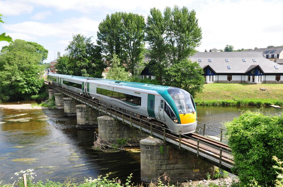 There is a train crossing a railway bridge that spans the River Slaney in Enniscorthy.