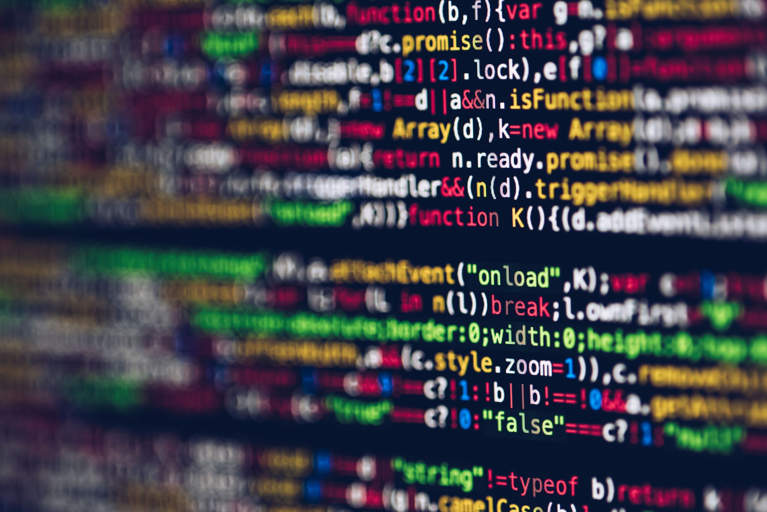 Vivid, blurred close-up of colorful code on a screen, representing web development and programming