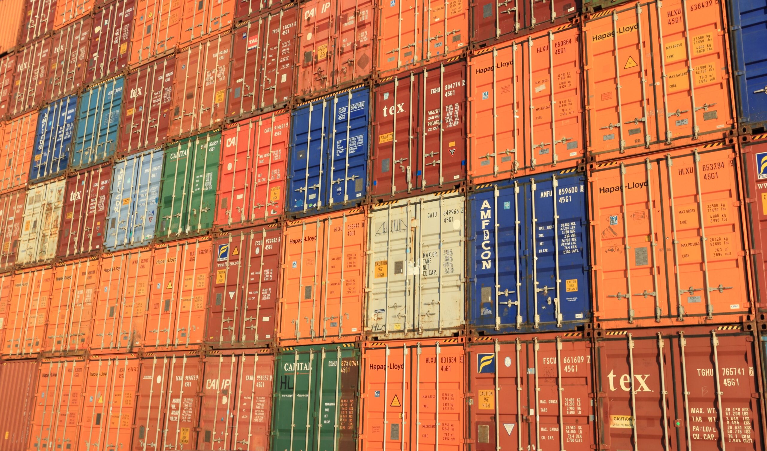 Colourful shipping containers stacked in a harbour