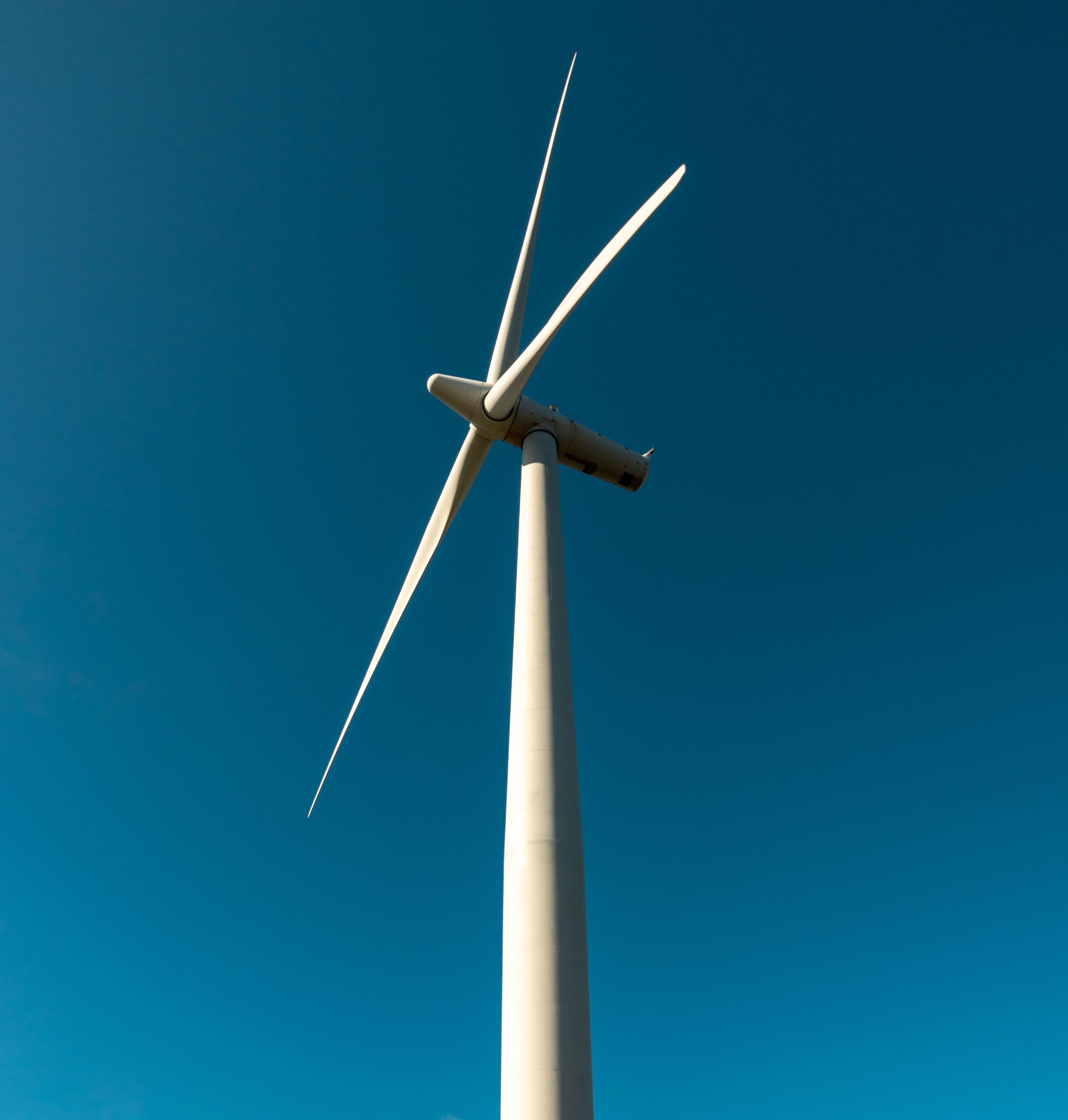 Looking up at a wind turbine from below