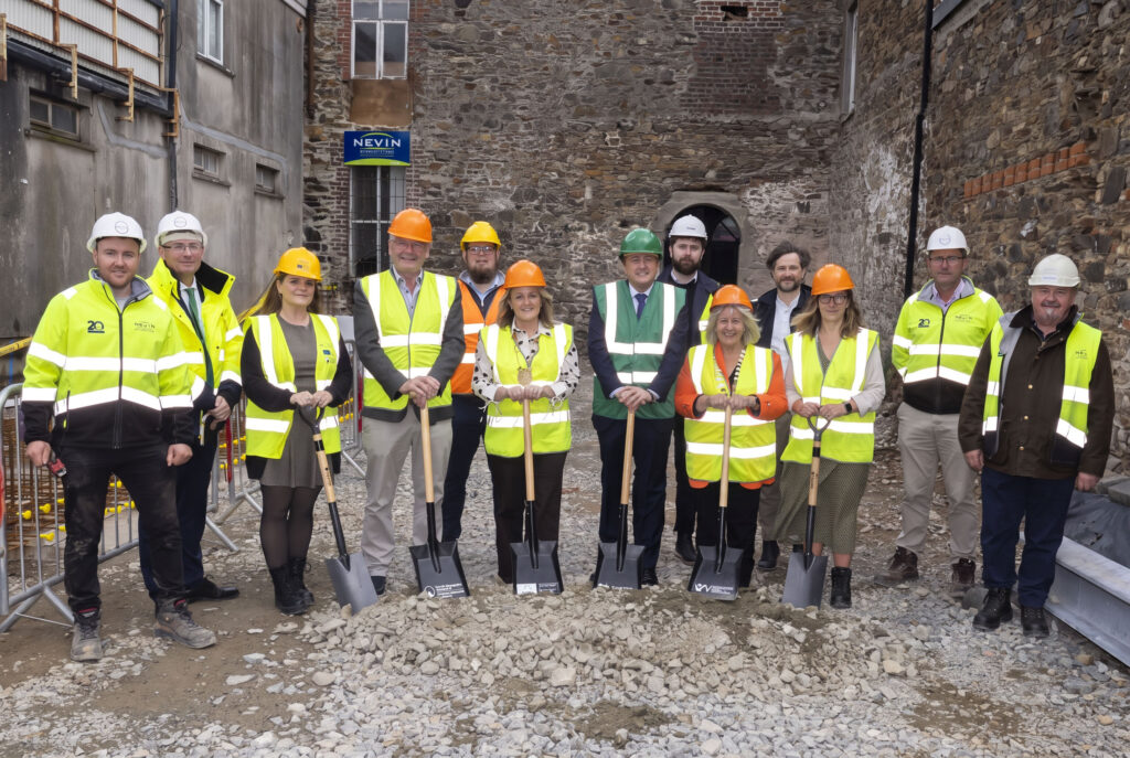 Turning of the sod at Gorey Market House with people in hi vis vests and hard hats on a construction site