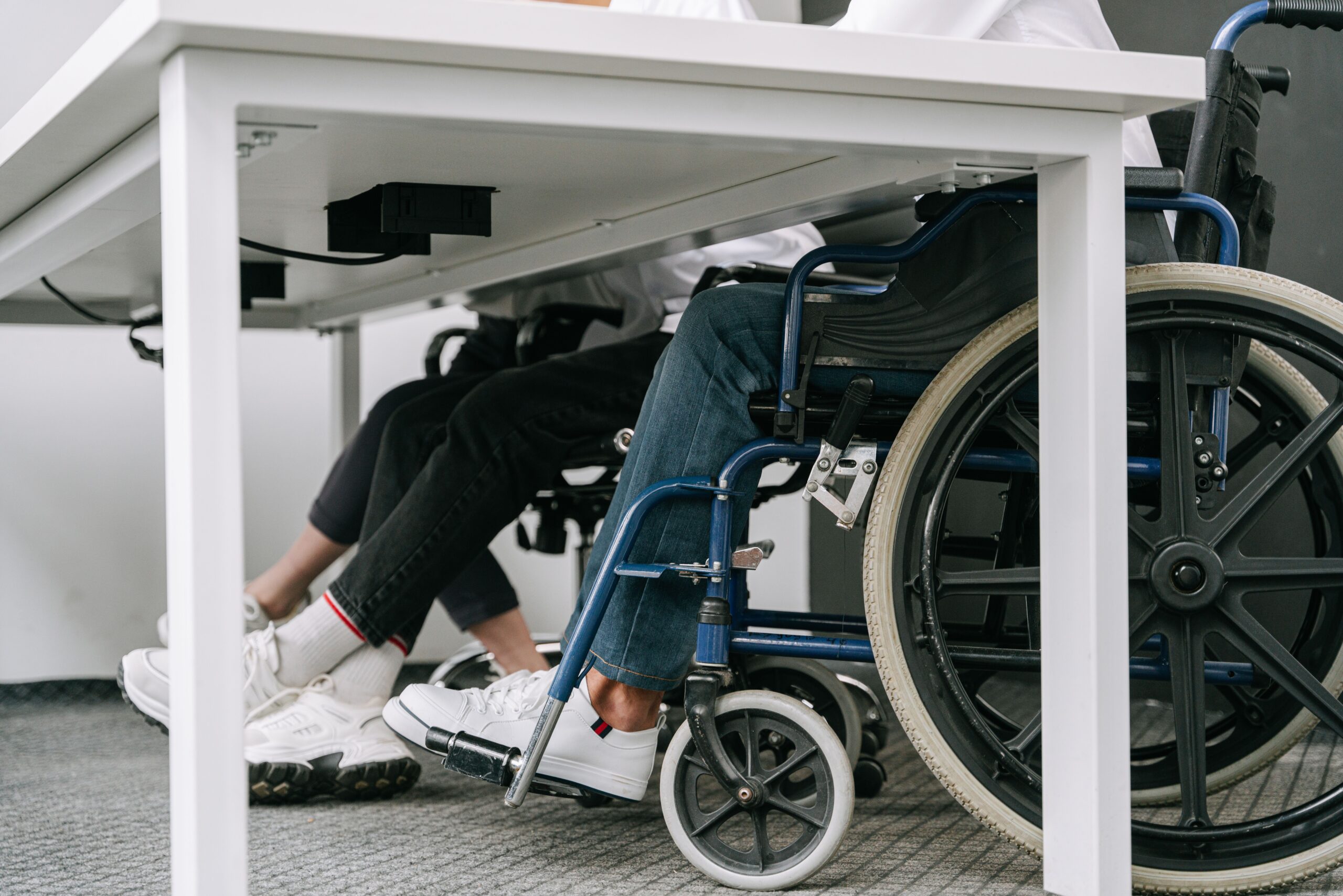 Wheelchair users sat at a table